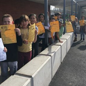 students holding kindness checklist